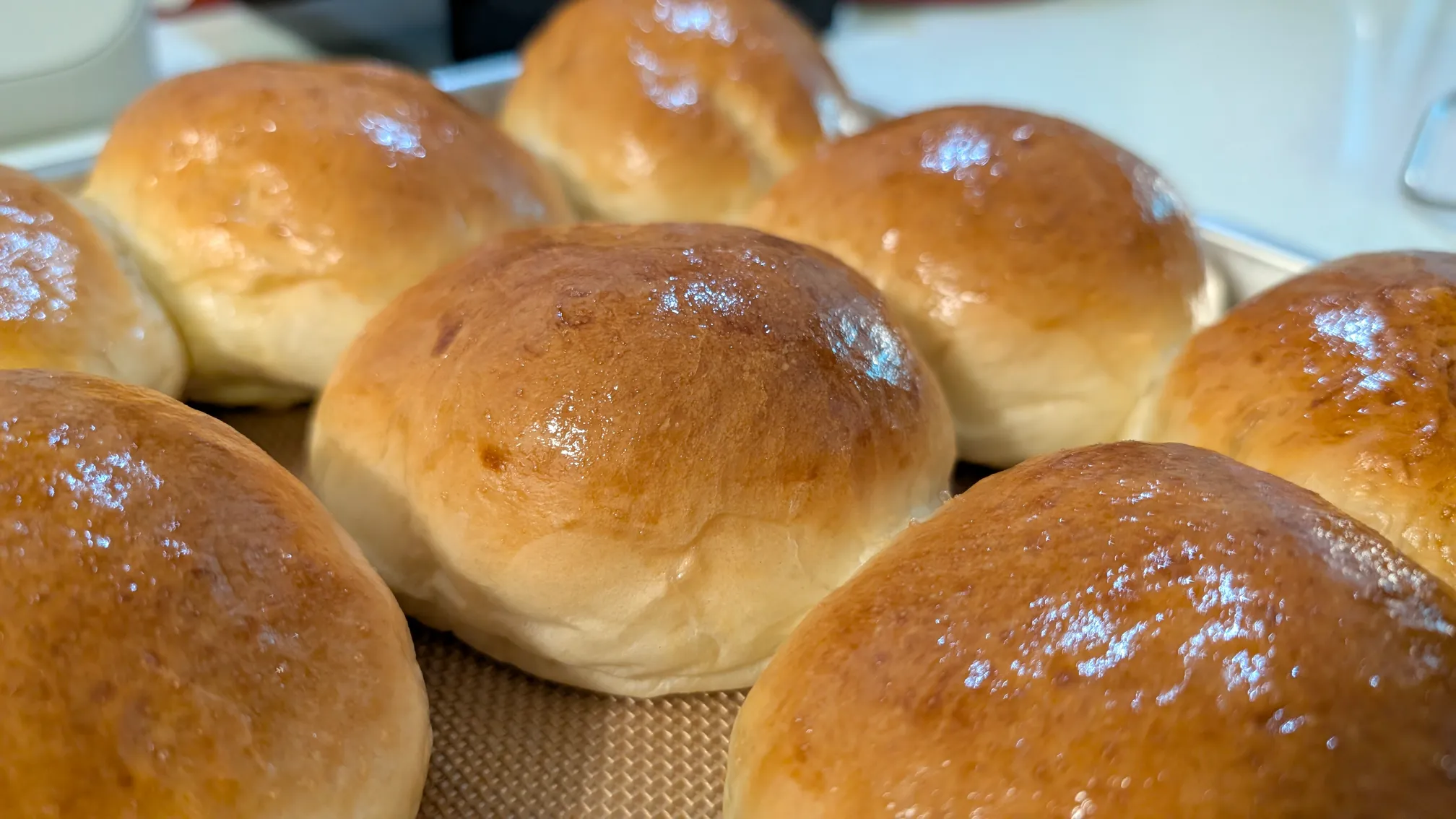 A closeup of golden brown brioche buns