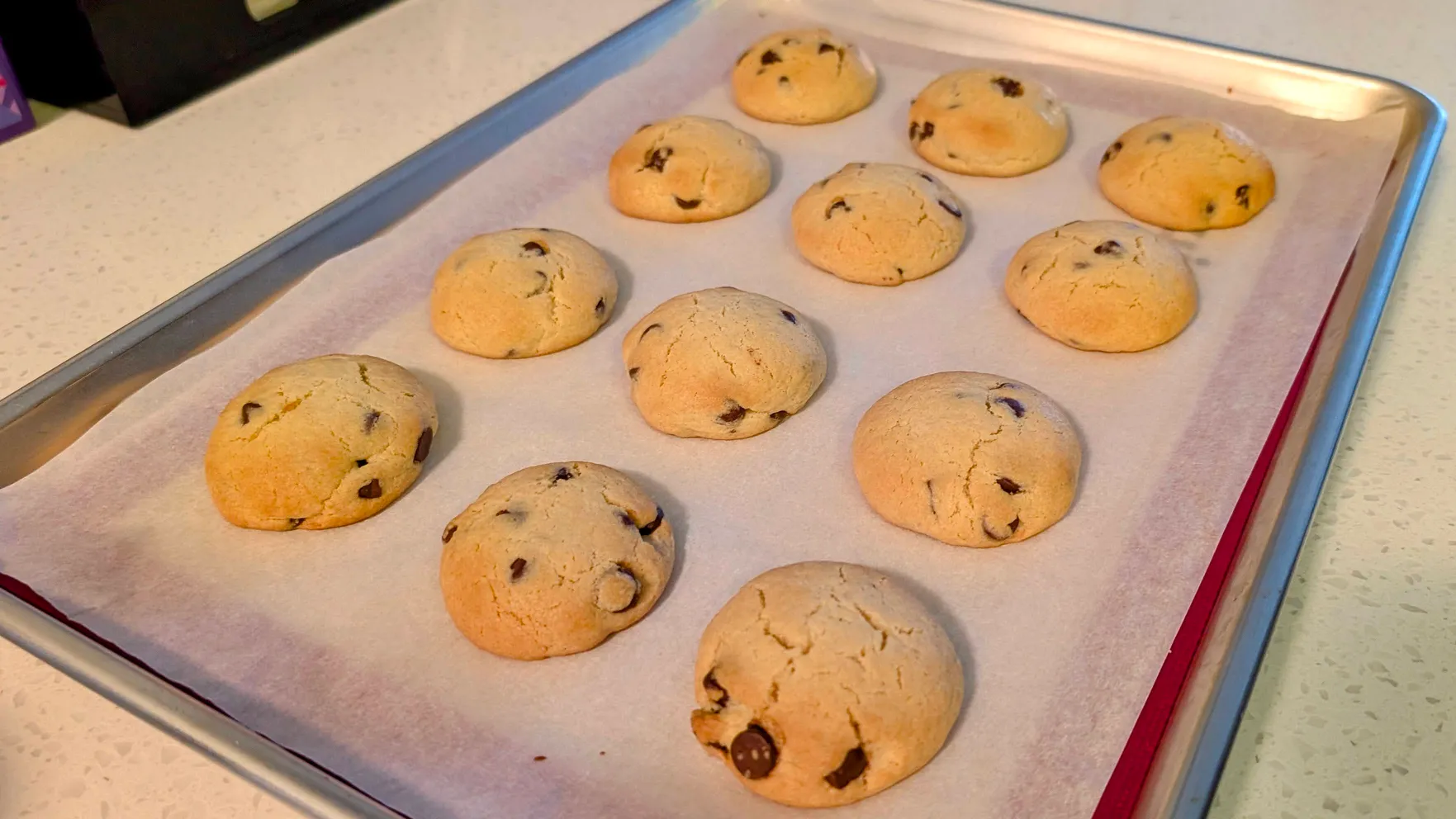 12 chocolate chip cookies on a baking sheet