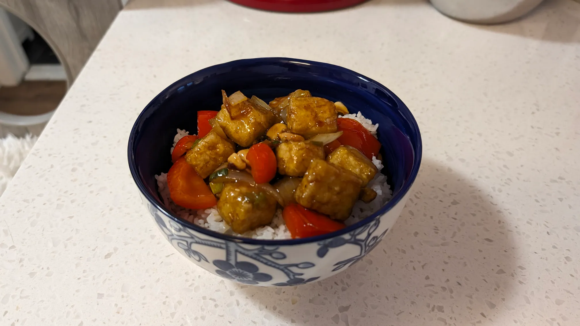 Kung Pao Tofu served in a bowl with rice